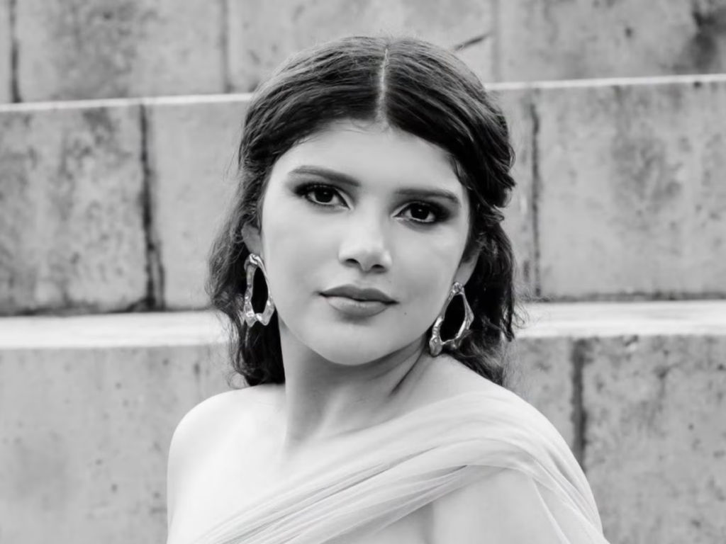 Portrait of a Woman in an Off-shoulder Dress with Large Hoop Earrings Against Stone Steps, in Black and White. • Guadalupe Informa