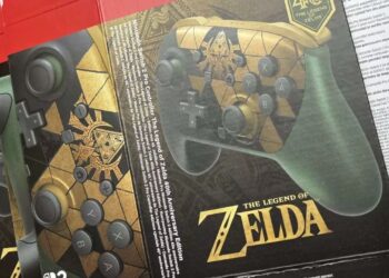 Close-up of a Zelda game box showing button prompts (Y, X, A, B) over a controller design with gold artwork and branding.