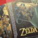 Close-up of a Zelda Game Box Showing Button Prompts (y, X, A, B) over a Controller Design with Gold Artwork and Branding. • Guadalupe Informa